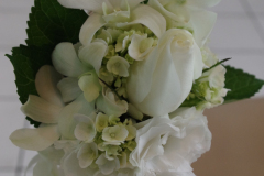 Elegant white floral arrangement featuring roses, hydrangeas, and greenery, ideal for wedding inspiration from Antaeus Flowers.